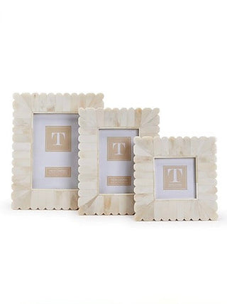 Set of three white scalloped picture frames with 'T' monograms