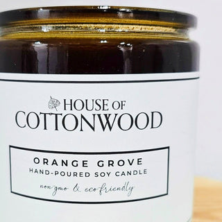 Candle jar labeled 'House of Cottonwood' with a bamboo lid