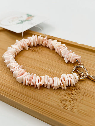 Peach beaded bracelet with gold clasp and hoop hardware