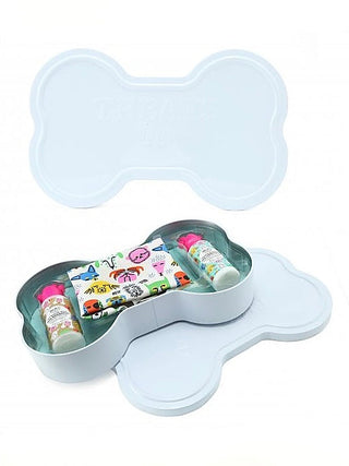 Light blue bone-shaped organizer tray with compartments holding small grooming items