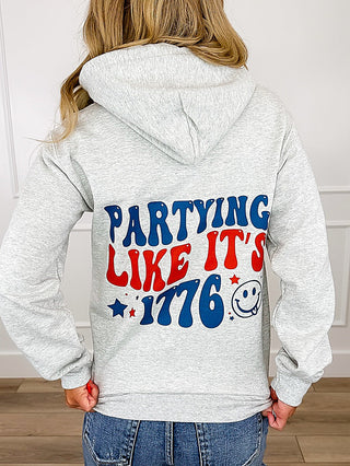 Grey long-sleeve hoodie sweatshirt with 'Partying Like It's 1776' back print