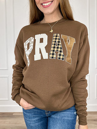 Brown crewneck long-sleeve sweatshirt with PRAY patchwork graphic