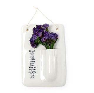 Porcelain hanging bud vase with purple flowers in white pocket