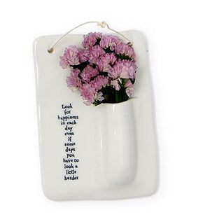 Porcelain hanging bud vase with pink flowers in white pocket
