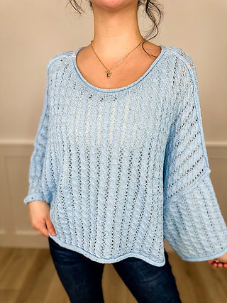 Light blue knit long-sleeve cropped sweater top with round neck and loose sleeves