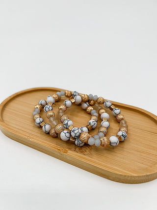 Beaded bracelet set with white stone beads and gold-tone spacers