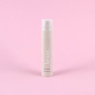 Coconut whitening toothpaste tube in white and beige with flip-top cap