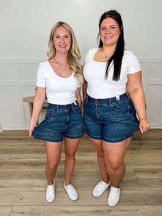 White short-sleeve fitted top with scoop neck, smooth knit fabric.