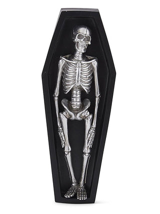 Black coffin-shaped resin decor featuring a resting silver skeleton figure