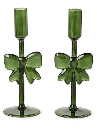 Two green ribbon bow glass candleholders with tall cups and pedestal bases