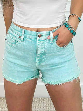 Mint green high-rise tummy control denim shorts with frayed hem, front pockets