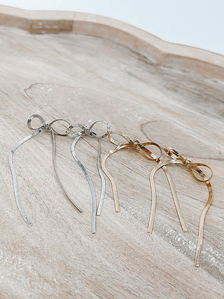 Drop earrings set in silver and gold with loop-and-chain drops and long pins
