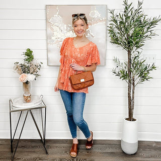 Orange paisley short-sleeve top with loose fit and scalloped neckline