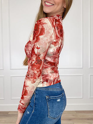 Sheer mesh long-sleeve top in cream with red floral print, fitted side view, high neck