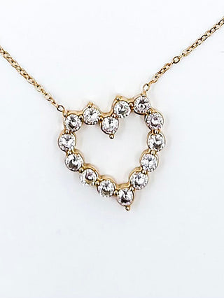 Gold heart pendant necklace with round rhinestone stones on a gold chain