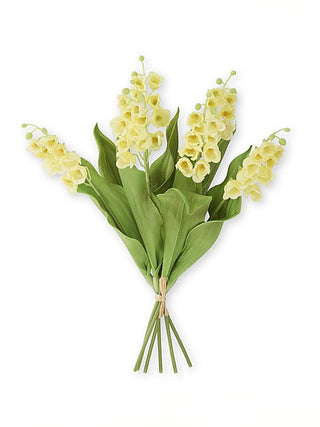 Yellow floral decor bouquet with clustered blossoms and green leaves