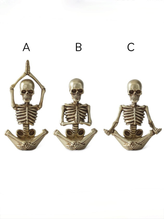 Gold resin skeleton decor variants A, B, and C, with skull heads and ribcages