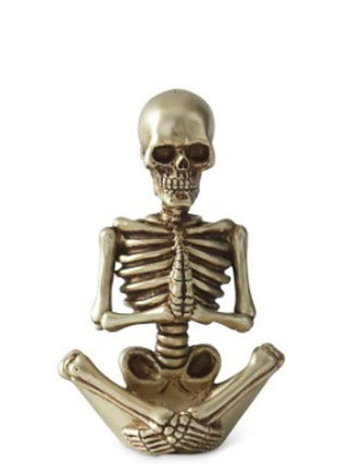 Gold-tone resin skeleton decor figure seated with arms down and skull face front