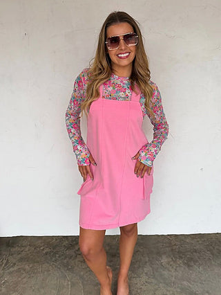 Pink overall dress with long floral sleeves, sleeveless bodice, side tie detail, pockets