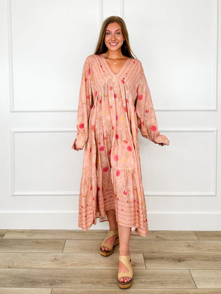 Pink floral print midi dress with long sleeves and a tiered skirt styled with tan wedge sandals.