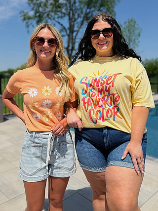Graphic tee and denim shorts outfit set with floral and sunset text tops