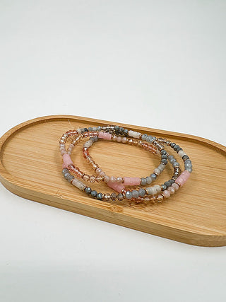 Beaded bracelet set with pink, gray, and gold-tone beads, layered loop style