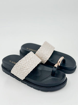 Faux leather slide sandals with natural textured strap and rose-gold metal buckle
