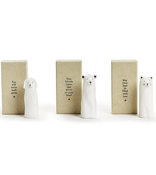 White porcelain bud vases shaped as dog, bear, and cat beside verse blocks.