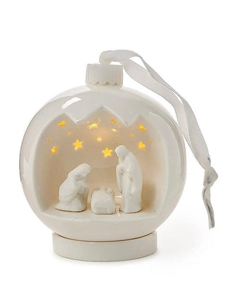 White porcelain nativity scene light-up ornament with hanging ribbon and glowing figures