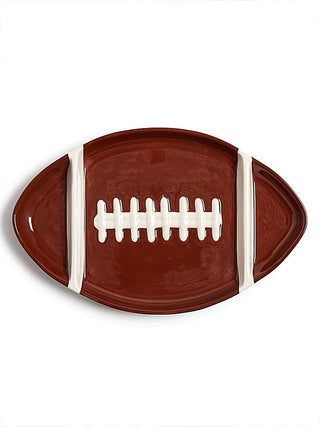 Brown ceramic football-shaped serving tray with white center stripe and laces