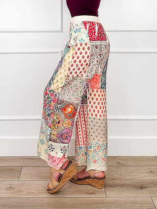 High-rise wide-leg pants in multicolor patchwork medallion print, side view.