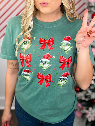 Green cotton short-sleeve graphic tee with cartoon faces and red bows