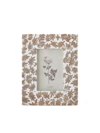 Wood picture frame with tan leaf print border and vertical photo opening