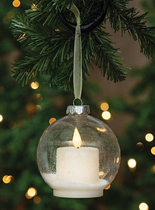 Hanging clear glass LED ornament with candle-like glow inside, frosted base