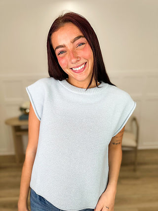 Light blue knit sweater top with cap sleeves and ribbed crew neck
