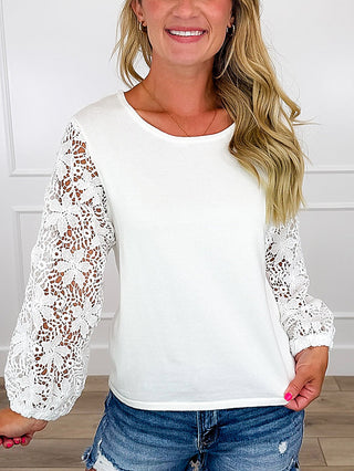 Ivory cotton-blend top with lace 3/4 sleeves and rounded neckline