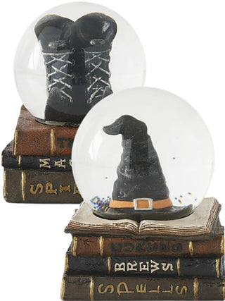 Wicked Cute snow globe with black boots on stacked spell books