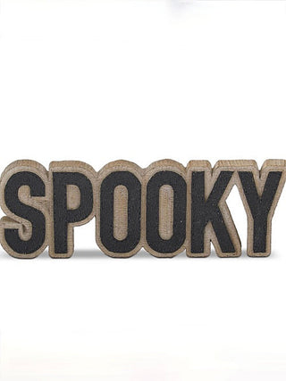 Wood shelf sitter sign reading “SPOOKY” with dark letters on natural wood backing
