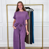 Women's matching lounge sets and two piece sets: purple short sleeve top and drawstring wide leg pant lounge set with more colors on a rack