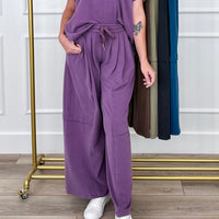 Women's lounge pants and wide leg lounge pants: purple drawstring knit lounge pants styled with white sneakers, with more colors on a rack