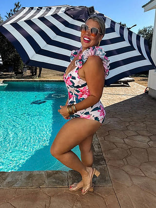 Pink floral swim dress with ruffled shoulder straps and V-neck, side view